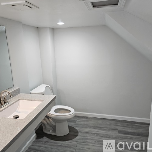 A room with a carpeted floor and a door leading to another room.