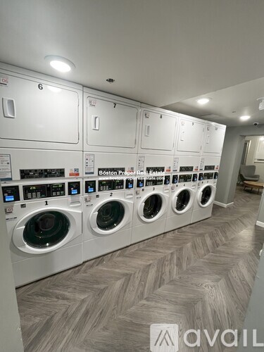 A row of washing machines in a laundromat.