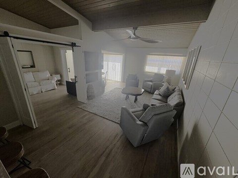 A living room with a white couch and a grey sofa.