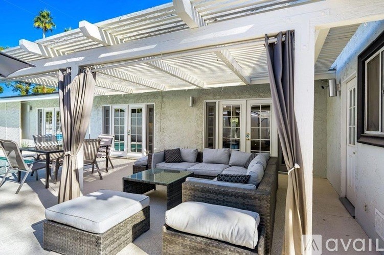 A sunny day at the patio with white furniture.