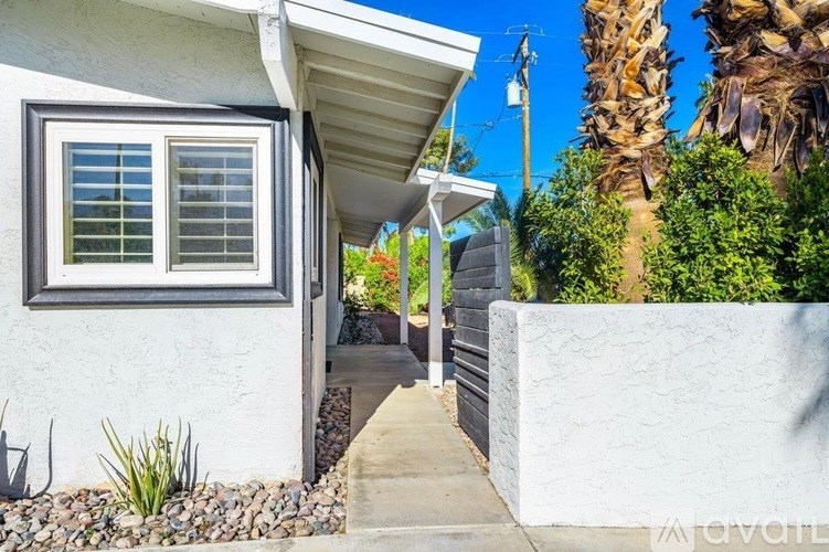 A white house with a window and a door.