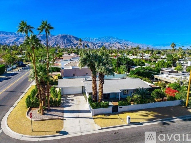 A house with a mountain in the background is for sale.