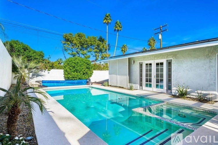A pool in front of a house with a sign that says "available".