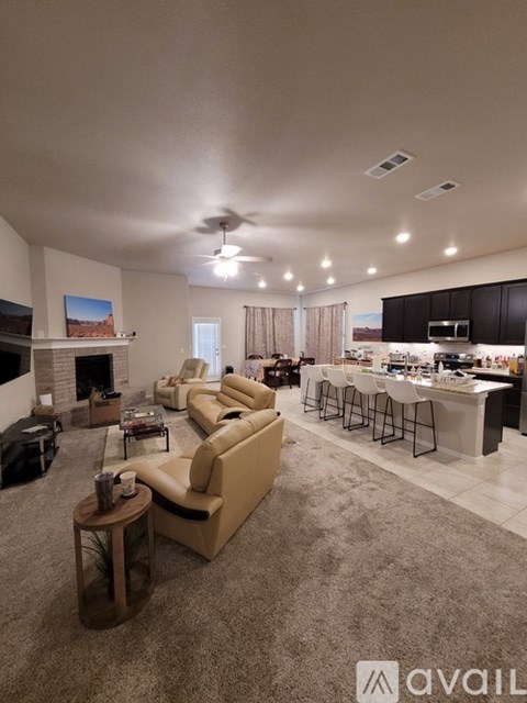 A living room with a fireplace and a bar area.