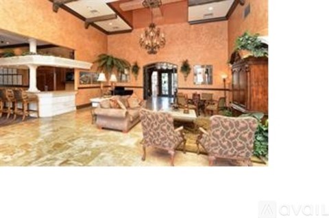 A living room with a sofa set and a chandelier.