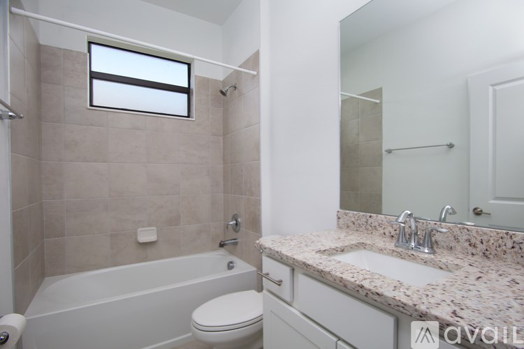 A kitchen with granite countertops and stainless steel appliances.