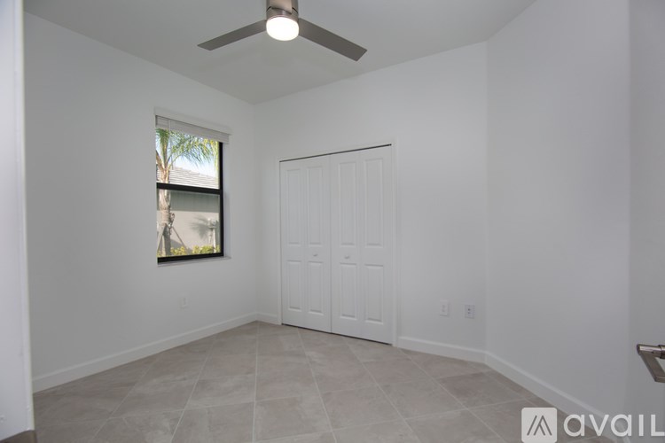 A modern kitchen with stainless steel appliances and white cabinets.