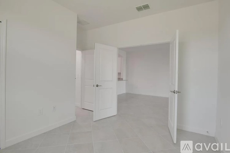 A room with two doors and a tiled floor.