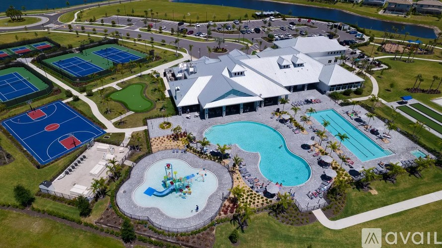 A large building with a pool in front of it.