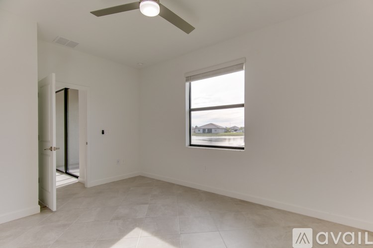 A bathroom with a sink, mirror, and shower.