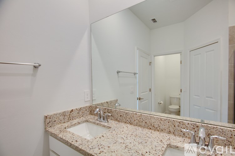 A house with a grey roof and two garage doors.
