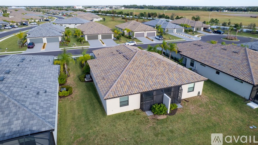 A bird's eye view of a suburban neighborhood with houses and driveways.