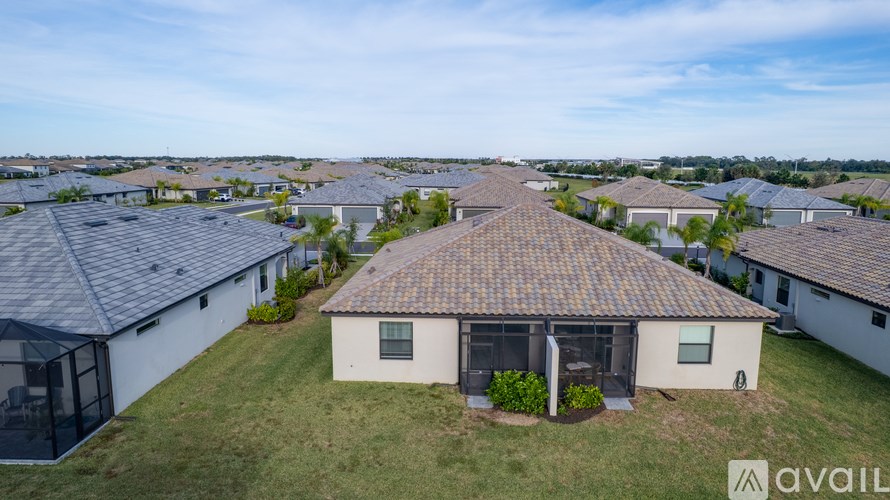 A house with a brown roof is surrounded by other houses with similar roofs.