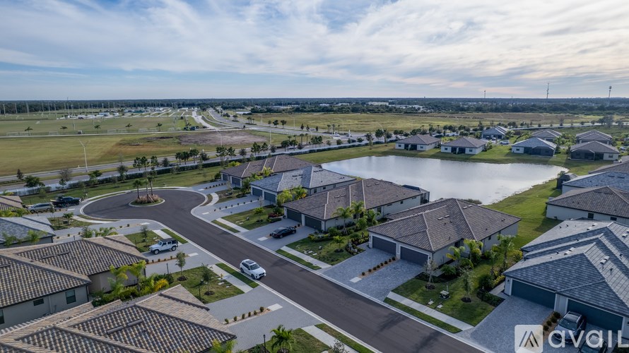 A bird's eye view of a residential area with houses and a roundabout.