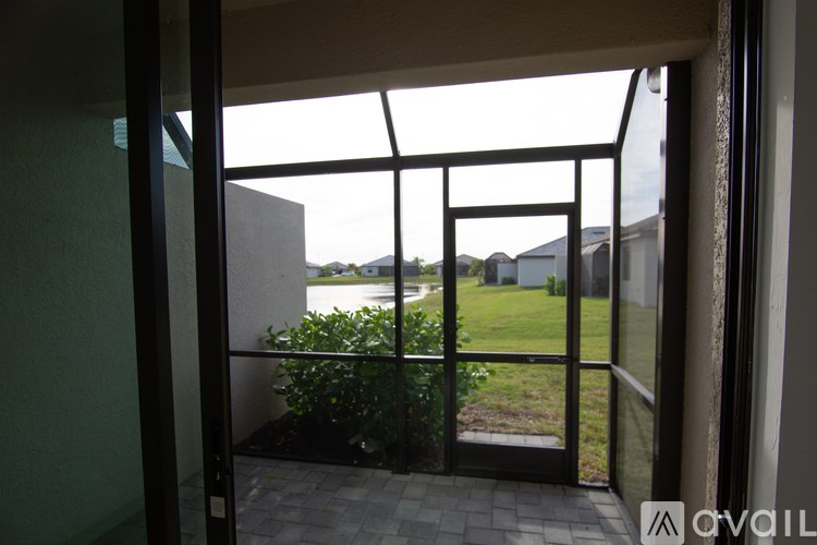 A balcony with glass doors leading to a backyard.