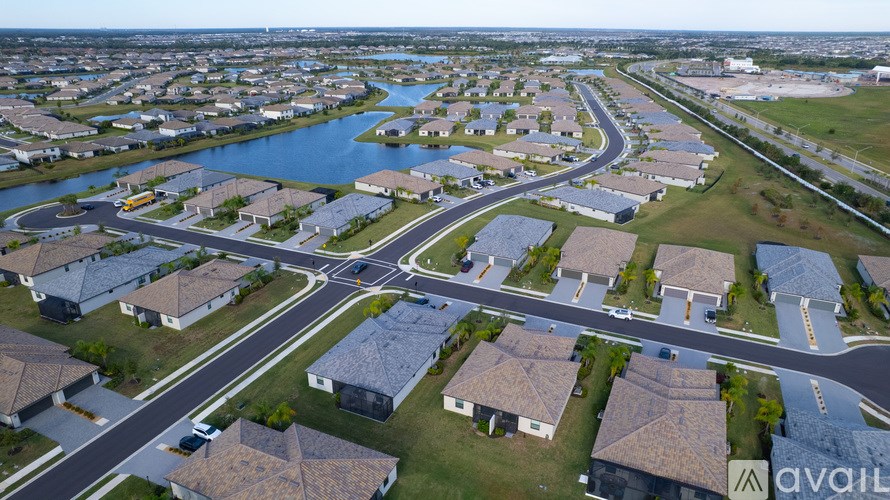 A bird's eye view of a residential area with houses and a river.