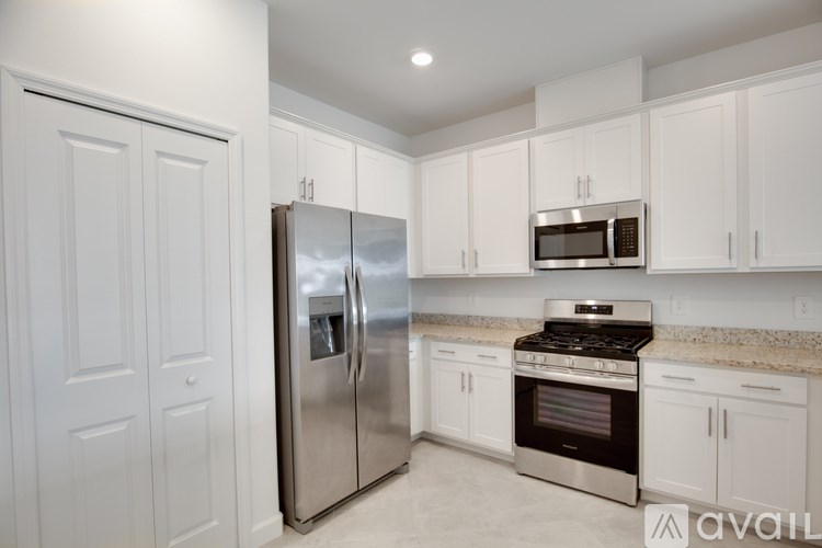 A bird's eye view of a community with a swimming pool and tennis courts.