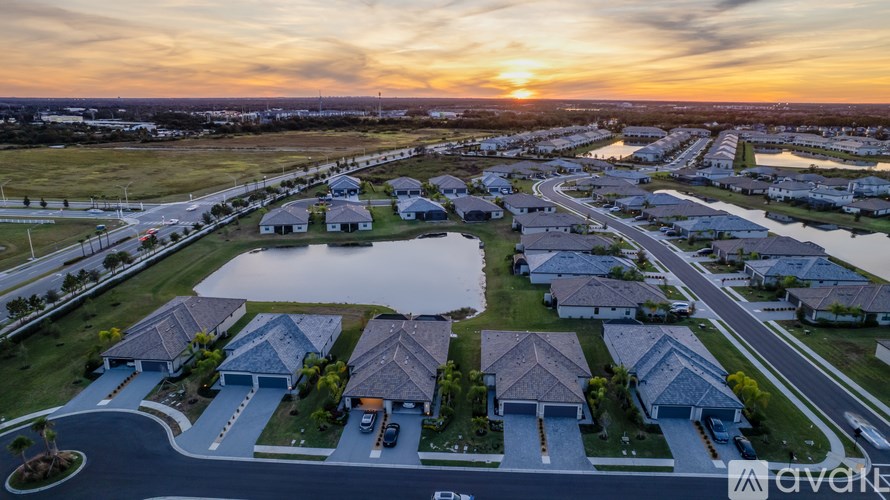 A sunset view of a residential neighborhood with houses and streets.