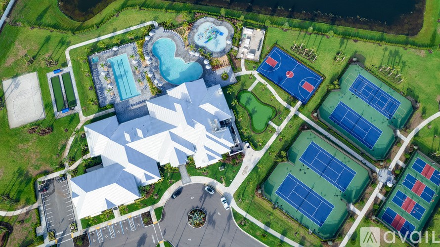 An aerial view of a sports complex with a swimming pool, tennis courts, and basketball courts.