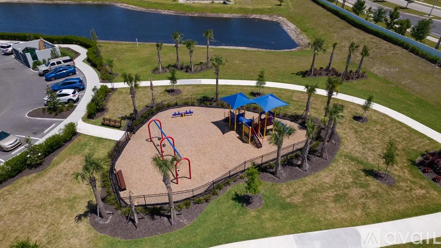 A playground with a blue umbrella and a slide.