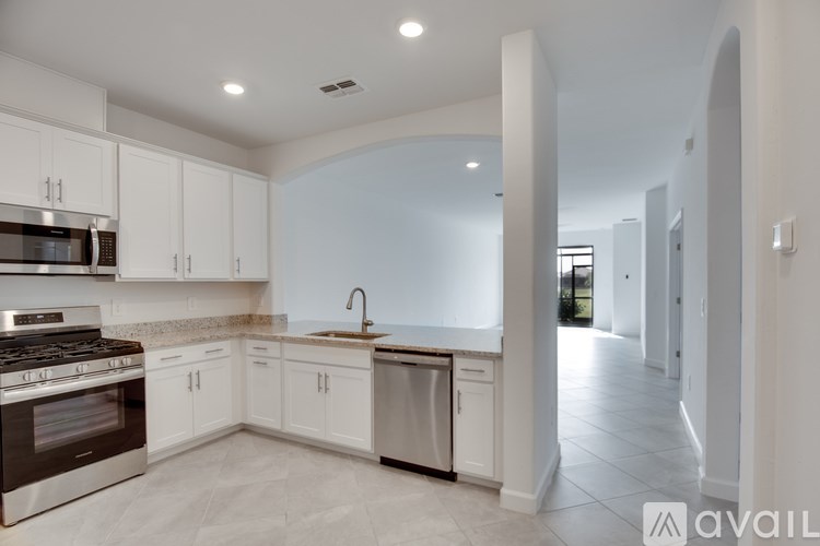 A room with a tiled floor and a doorway leading to another room.