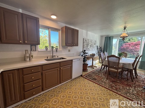 A kitchen with brown cabinets and a patterned floor.