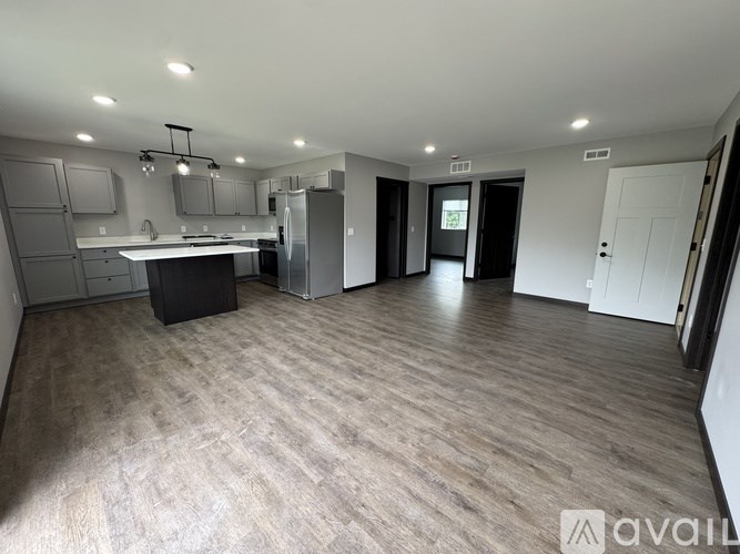 A spacious kitchen with a dining area and a refrigerator.
