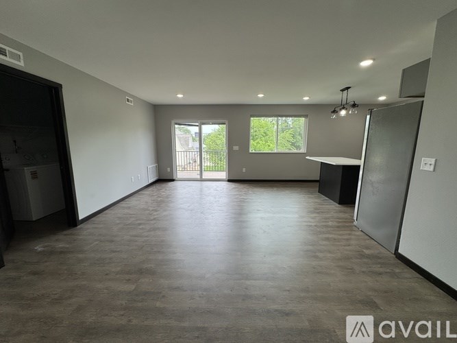 A spacious room with a door leading to a balcony.