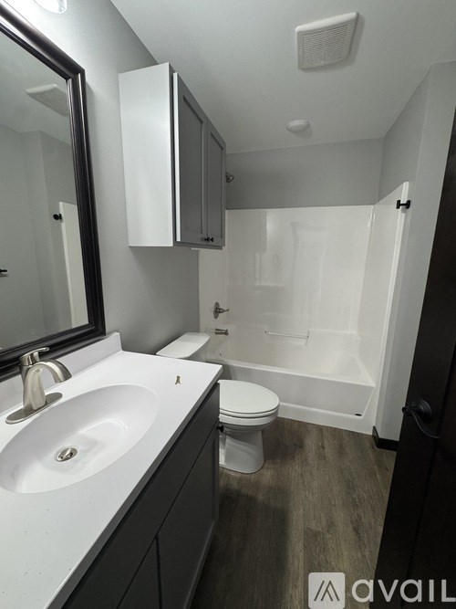 A bathroom with a sink, toilet and bathtub.