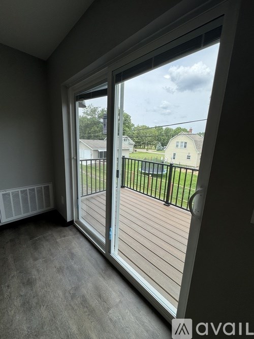 A room with a sliding glass door leading to a deck.