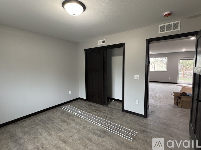 A room with a door and a wall socket.