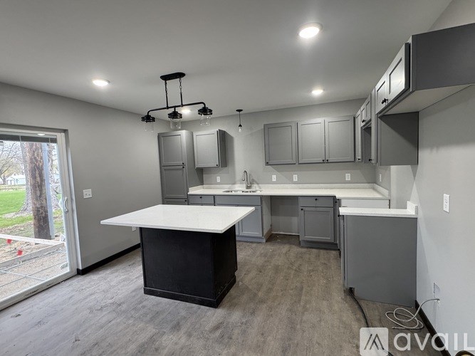 A modern kitchen with a large island in the center.