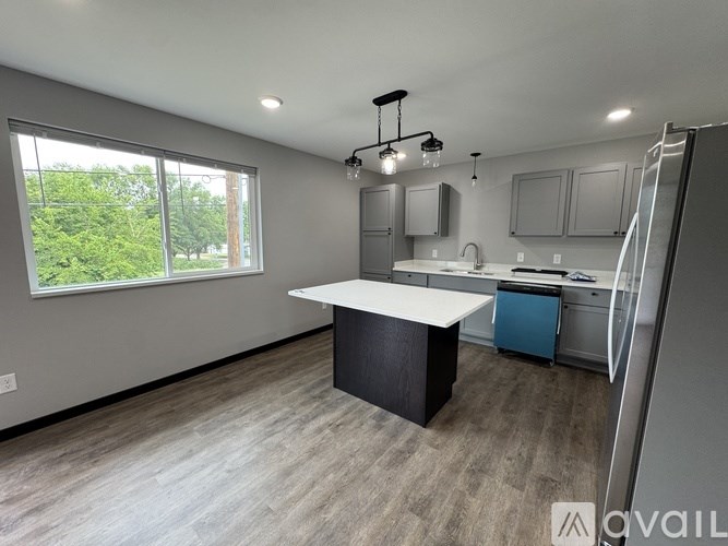 A kitchen with a large island in the middle of the room.