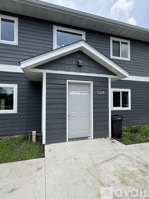 A grey house with the number 524 on the front door.