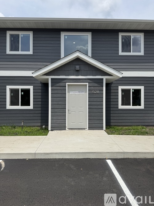 A grey house with the number 528 on the door.