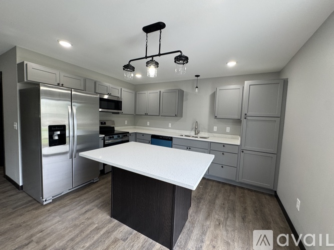 A modern kitchen with a large island in the center.