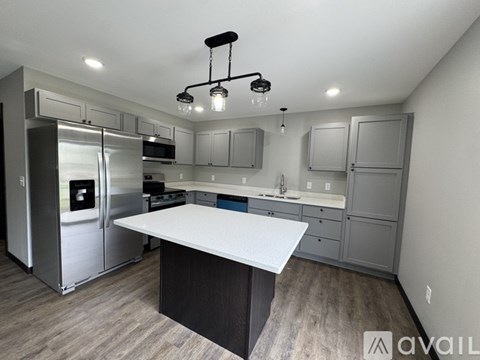 A modern kitchen with a large island in the center.