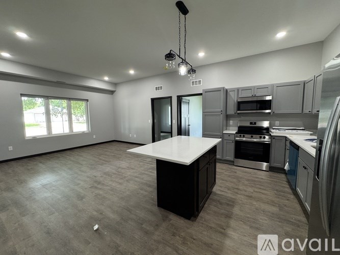 A modern kitchen with a large island in the center.