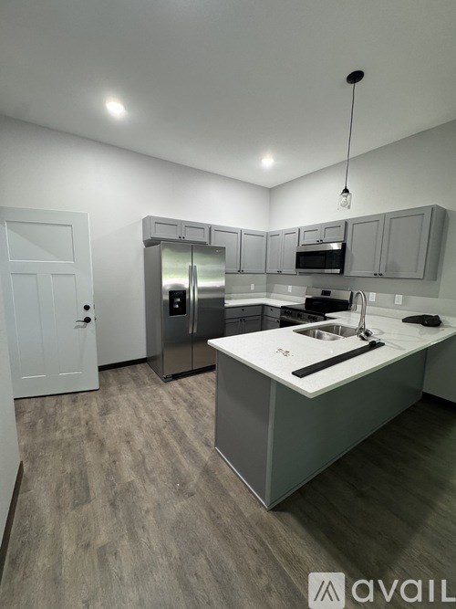 A kitchen with a white door and a sink.