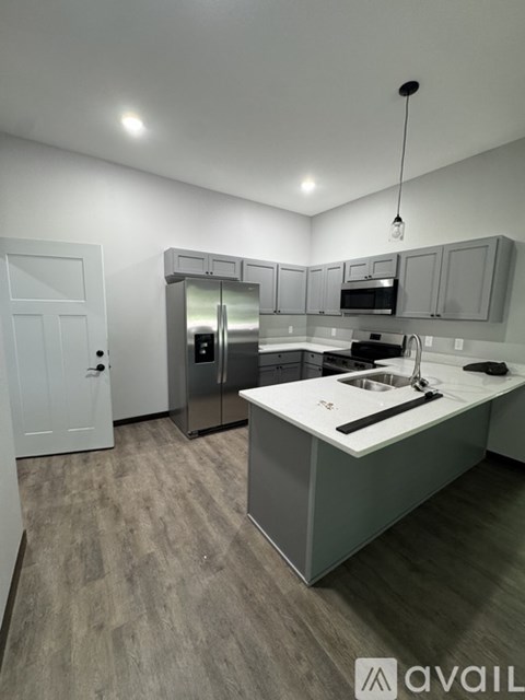 A kitchen with a white door and a sink.