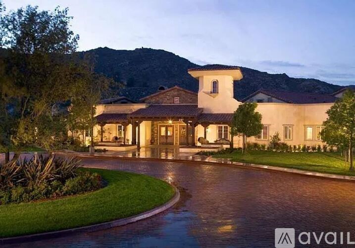 A large house with a driveway in front of it.