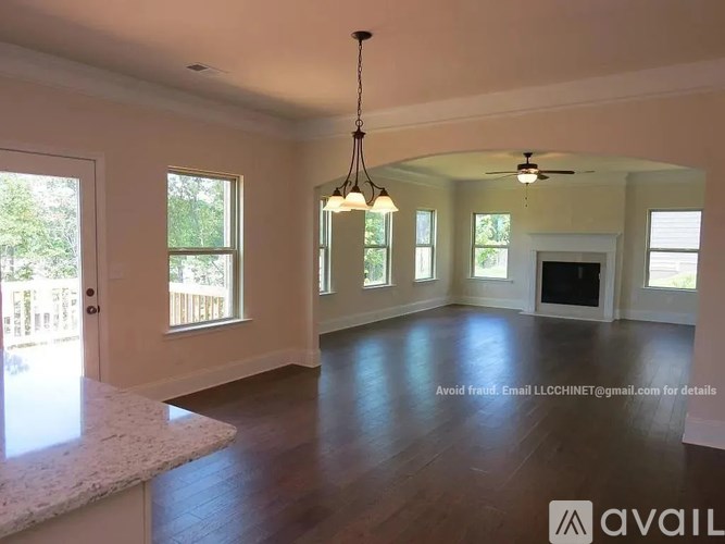 A spacious living room with a marble countertop and a chandelier.