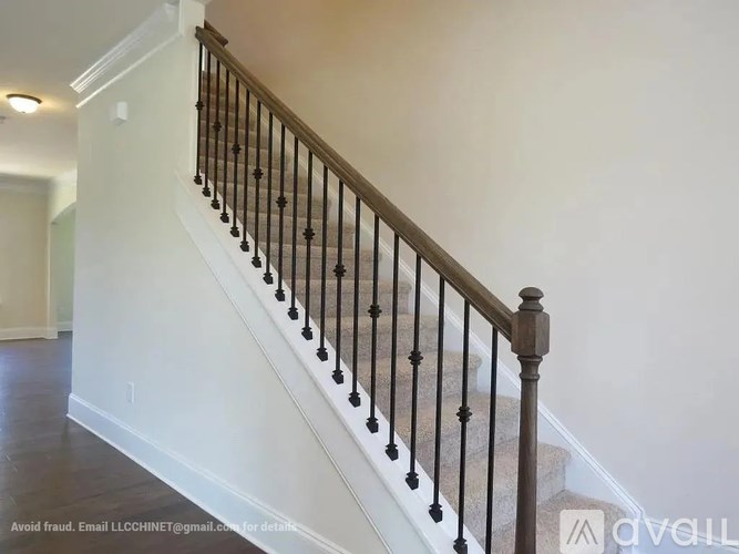 A staircase with a black railing and wooden steps.