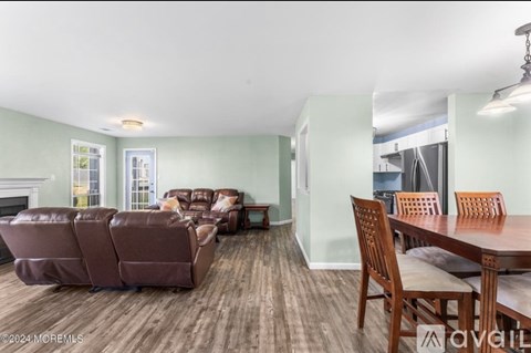 A living room with a brown couch and a wooden table.