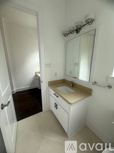 A bathroom with a sink and mirror.