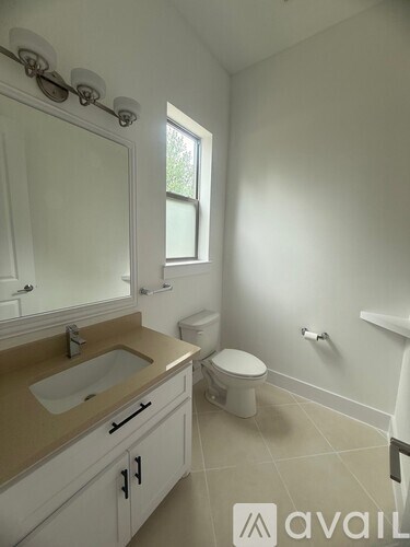 A bathroom with a sink, toilet, and bathtub.