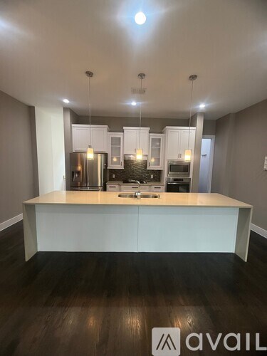 A kitchen with a white island in the middle of the room.