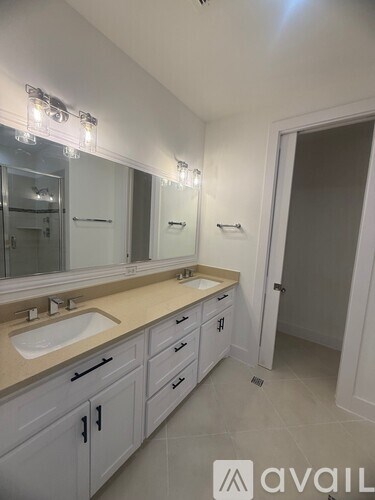 A bathroom with a sink, mirror, and cabinetry.