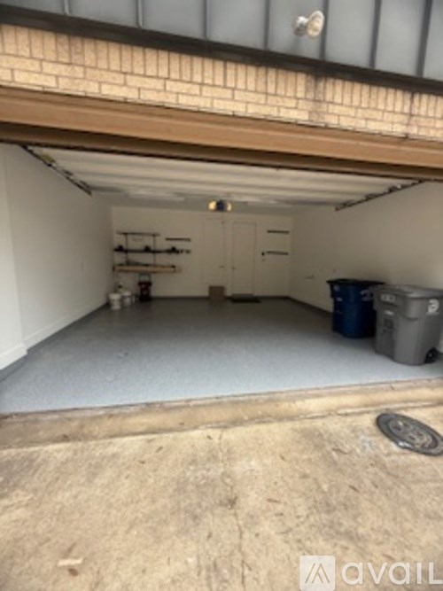 A storage room with a white floor and a blue container on the right side.