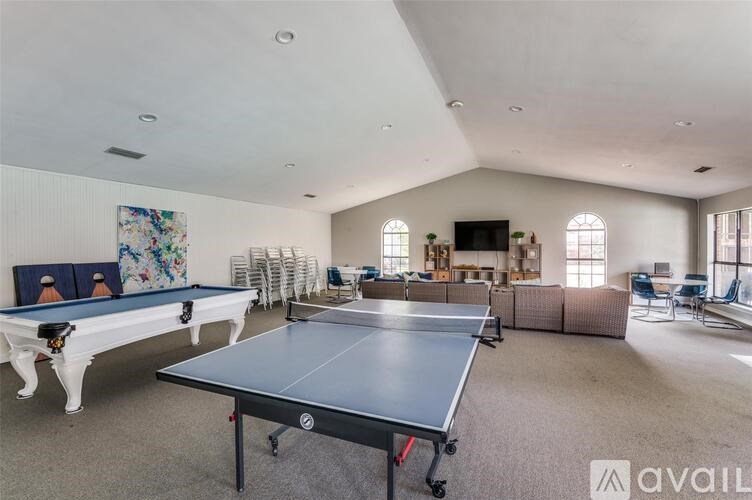 A room with a pool table and a ping pong table.